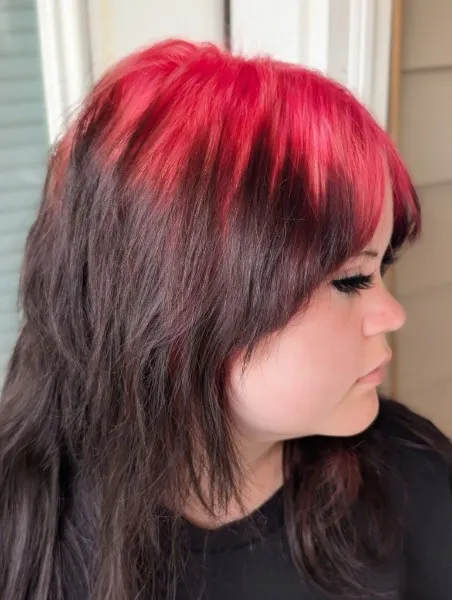 Layered dark brunette cut with bright red color through the bangs and crown